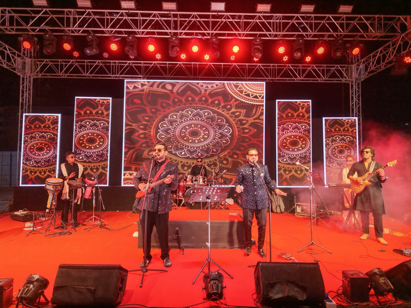 Bhajan Clubbing Mumbai performing live on stage with a mandala LED backdrop