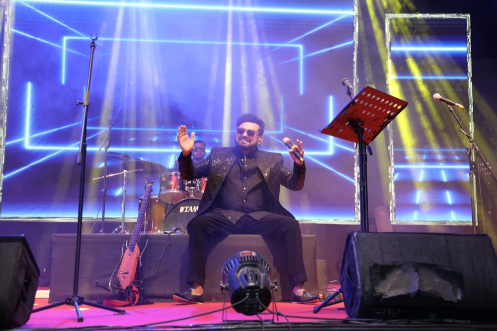 Lead vocalist performing a bhajan live on stage